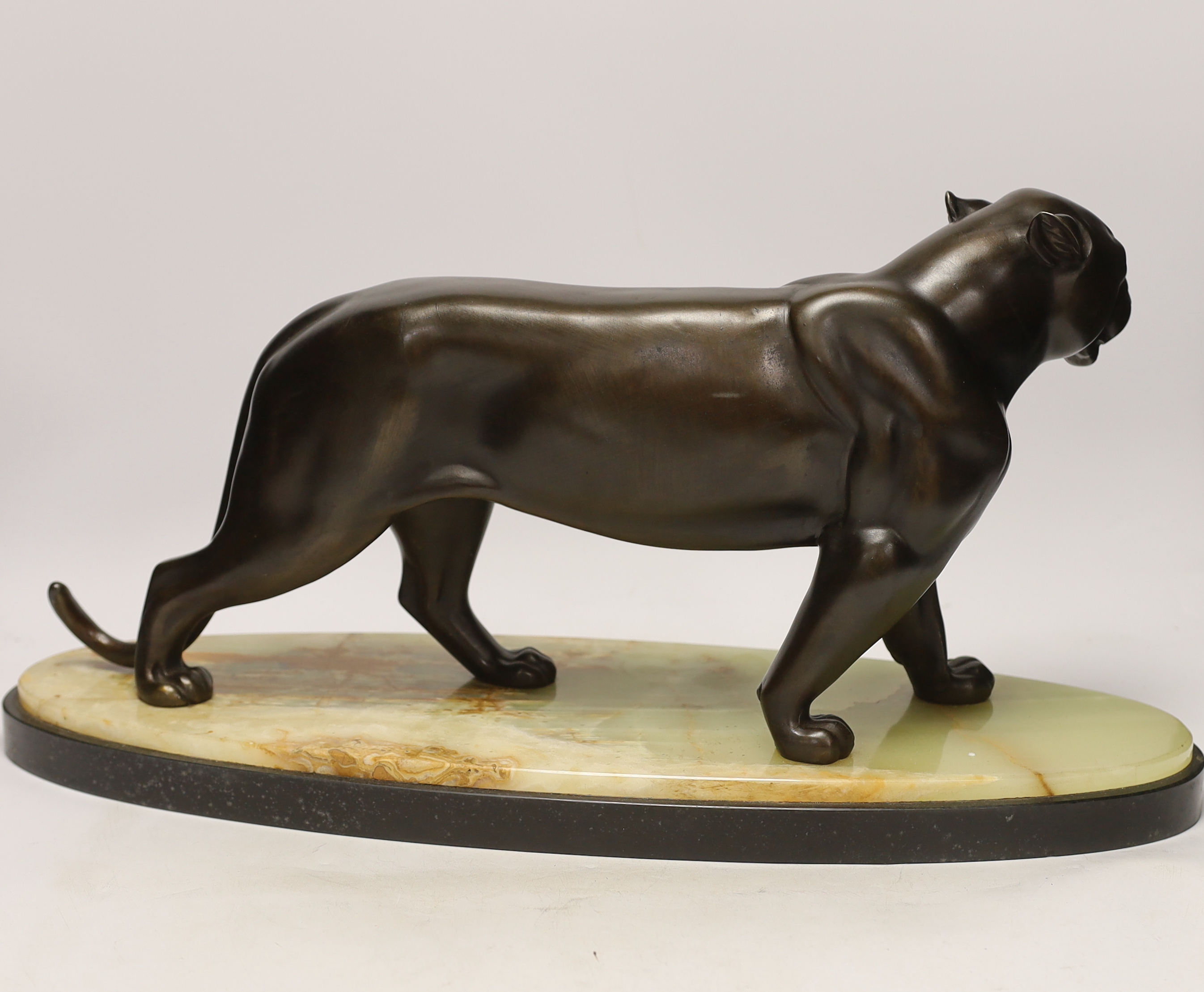 An Art Deco bronzed spelter figure of a panther, attributed to Rochard, on marble base, 56cm long